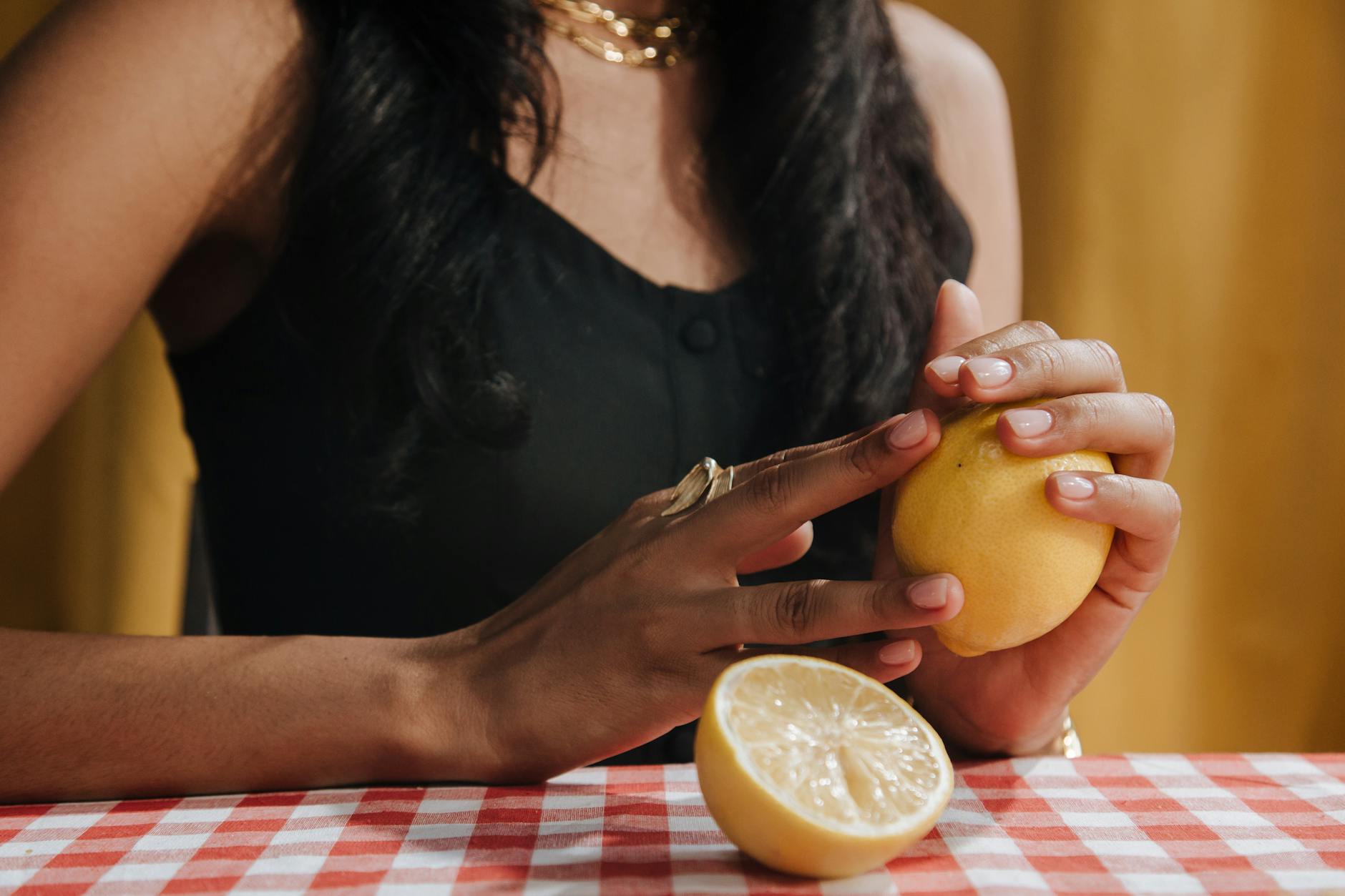 Woman holding fresh lemon, representing natural approaches to pleasure and sensation