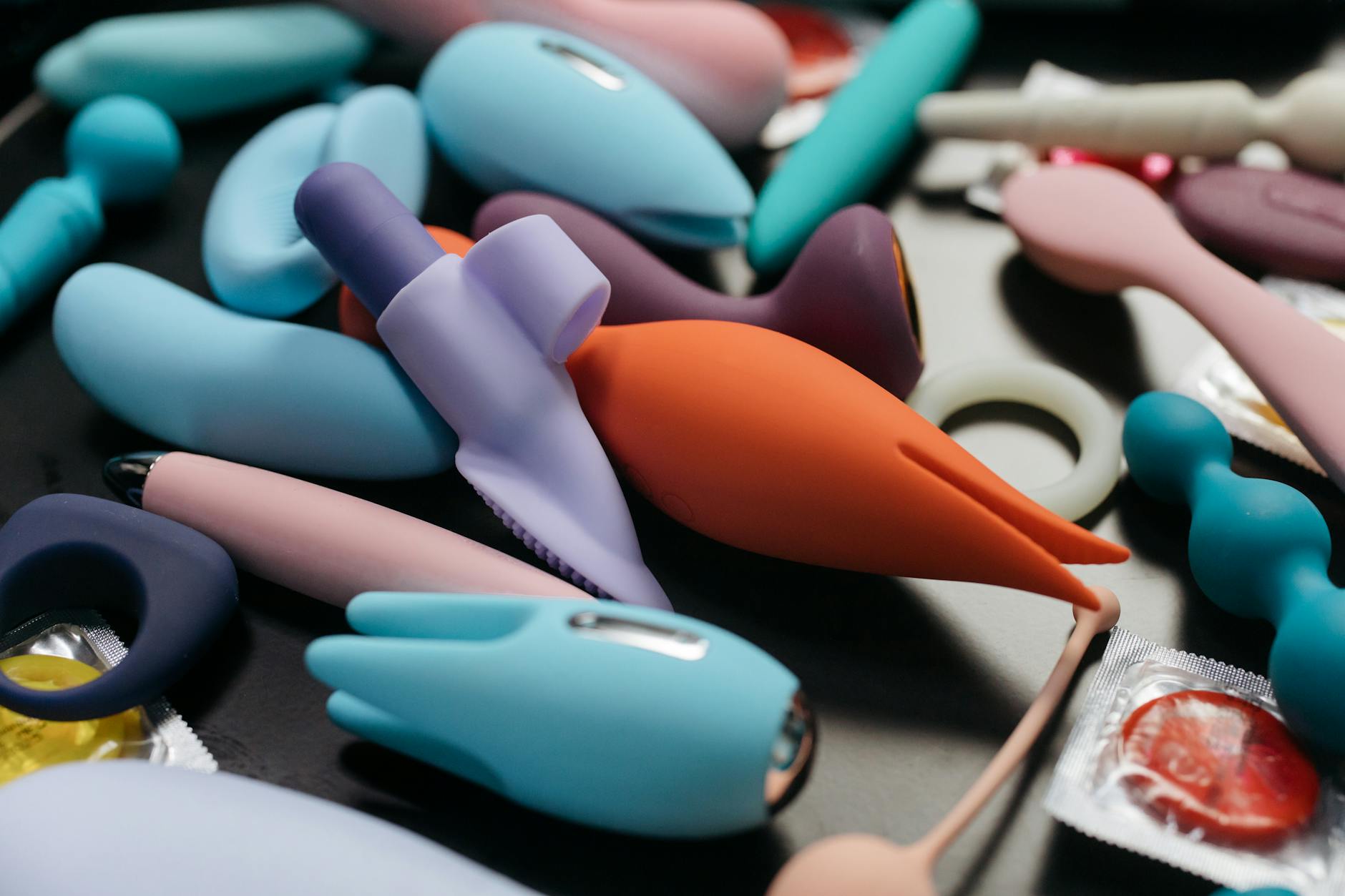 Woman holding vibrators and smiling, representing confident choices in sexual wellness during recovery